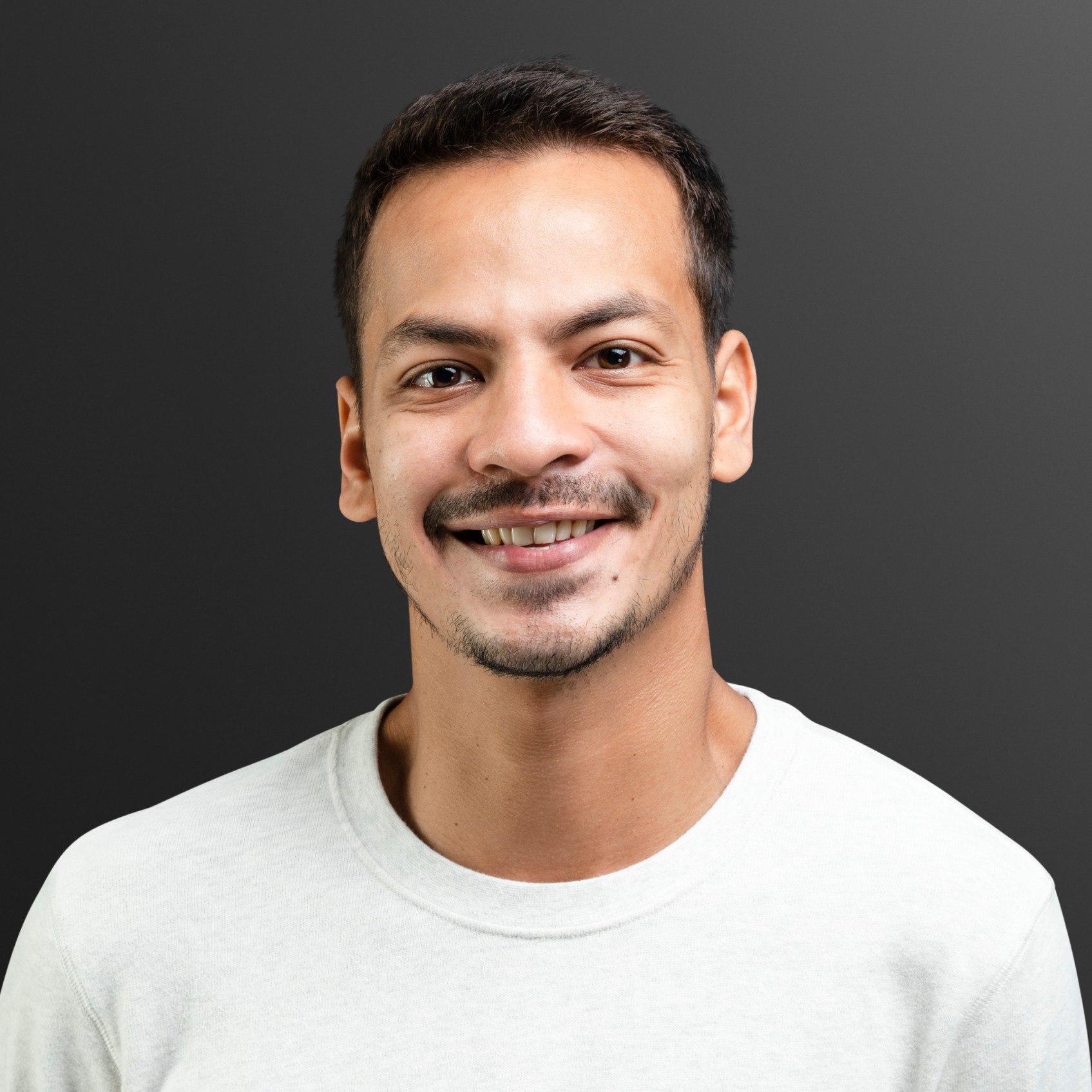 smiling man in white long sleeve tee portrait ynpwerg.jpg